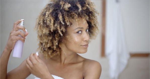 black woman maintaining her hair system with DIY Homemade hair products