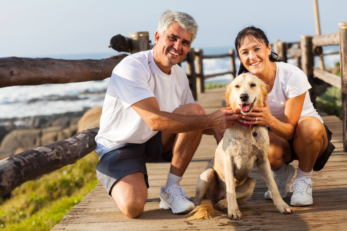 Middle age couple waking thedog and enjoying the life of a Hair System Wearer