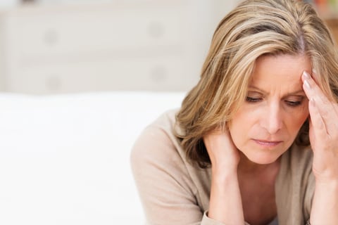 Middle age woman worried about her hairpiece getting damaged from the sun exposure